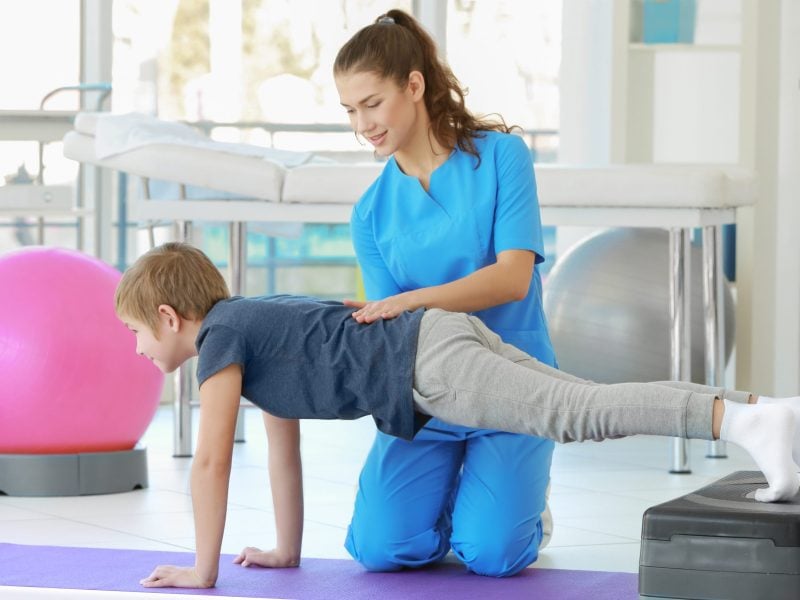 Physiotherapist working with patient in clinic