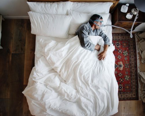 man-sleeping-with-anti-snoring-mask