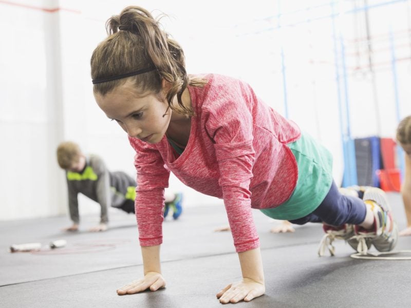 Determined girl practicing plank-holds