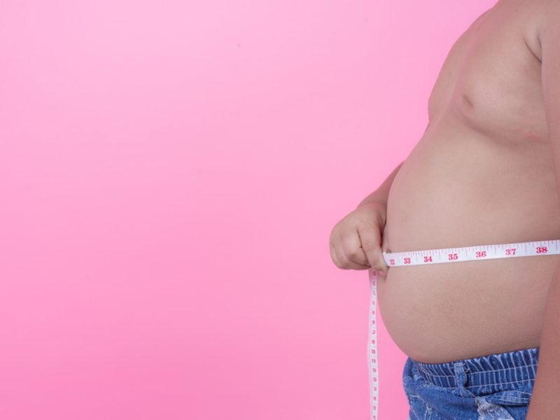 obese-boy-who-is-overweight-pink-background